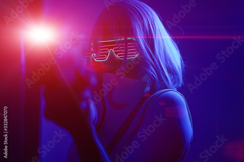 Girl with blaster in the futuristic battle. Concept virtual reality, cyber game.