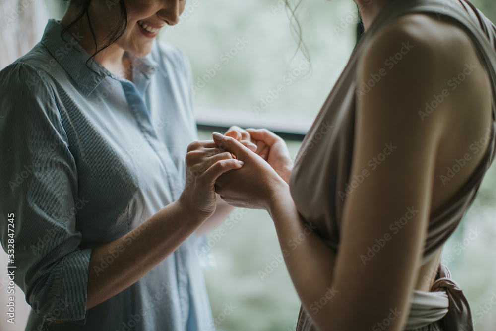 Fototapeta premium two friendly soulmates sisters holding eachother hands. bride getting prepared for the wedding