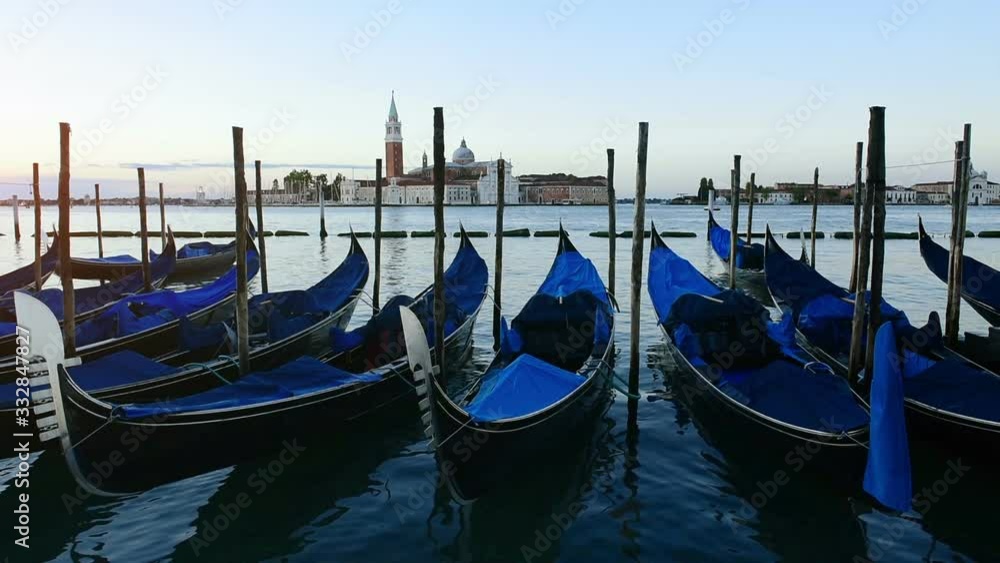 Row of traditional gondolas from Piazza San Marco with San Giorgio Maggiore view in the background Venice Italy. Row of traditional gondolas from Piazza San Marco with San Giorgio Maggiore view in the background Venice Italy.