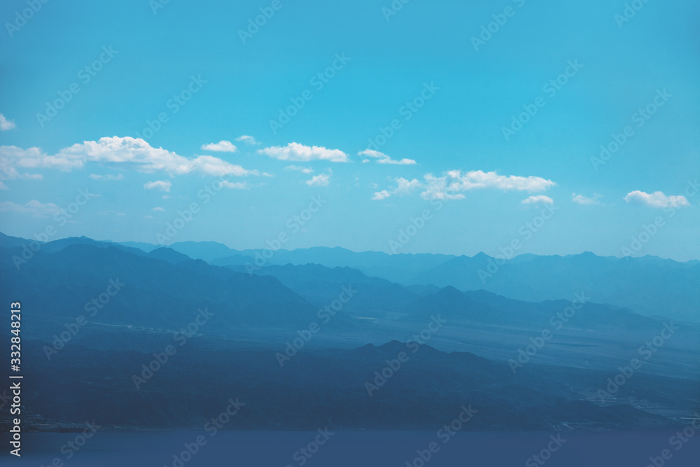 Silhouette of mountains in the early misty morning. Panorama of mountains ridge. Beautiful nature landscape