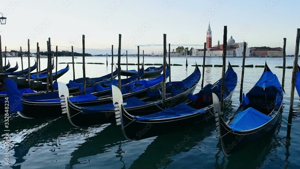 Gondolas boats parking at sunset. Italian gondolas paddle boats docked at San Marco, sunset in Venice, Veneto, Italy. Gondolas boats parking at sunset. Italian gondolas paddle boats docked at San Marco, sunset in Venice, Veneto, Italy.