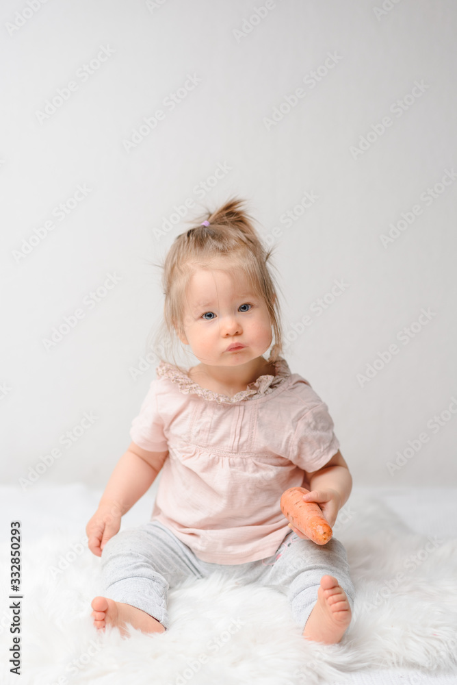 Sweet baby eating her first carrot