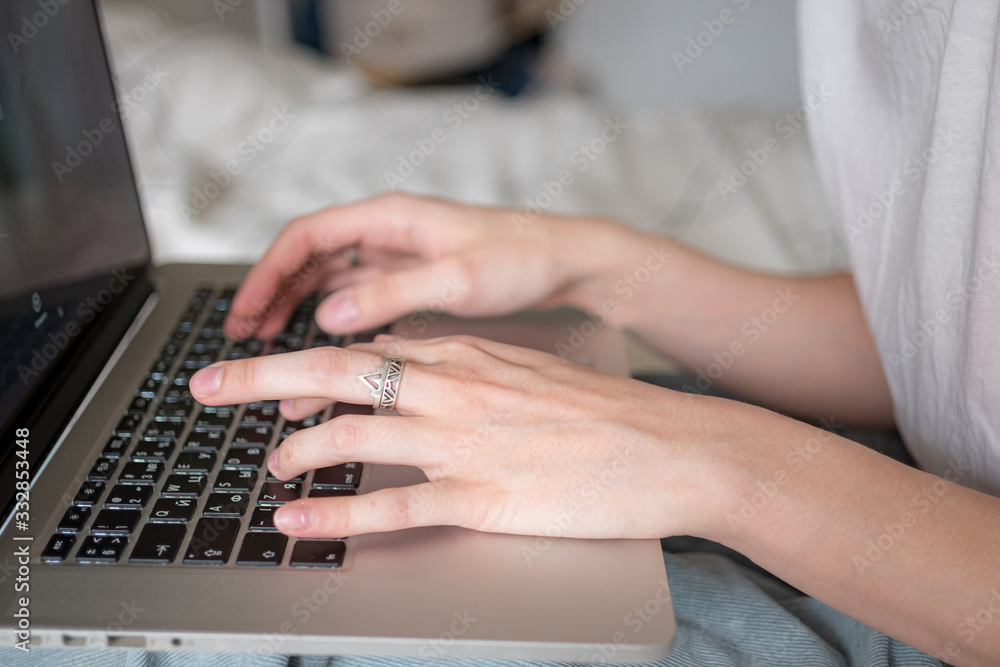 Woman's hands working on laptop at home. Distance work, distance education, home office close up. Selective focus Woman's hands working on laptop at home. Distance work, distance education, home office close up. Selective focus