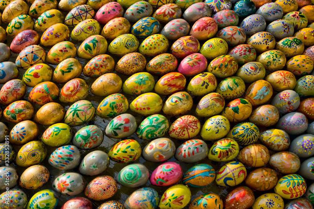 Many beautiful multi-colored religious eggs lie nearby Many beautiful multi-colored religious eggs lie nearby
