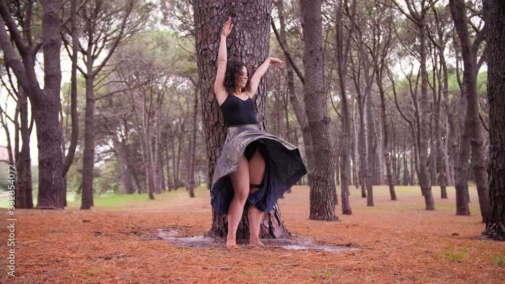 A Woman Gracefully Doing A High Kick Dance In The Middle Of Centennial Park In Australia. -medium shot A Woman Gracefully Doing A High Kick Dance In The Middle Of Centennial Park In Australia. -medium shot