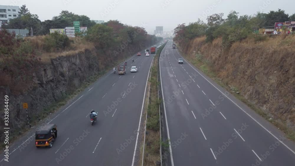 Multi-lane Mumbai Bangalore highway traffic near Pune, road travel in India Multi-lane Mumbai Bangalore highway traffic near Pune, road travel in India