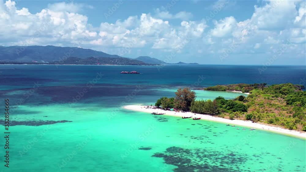 Tropical island Aerial view. Camera flies over the shore and the beach of the tropical island. Tropical island Aerial view. Camera flies over the shore and the beach of the tropical island.