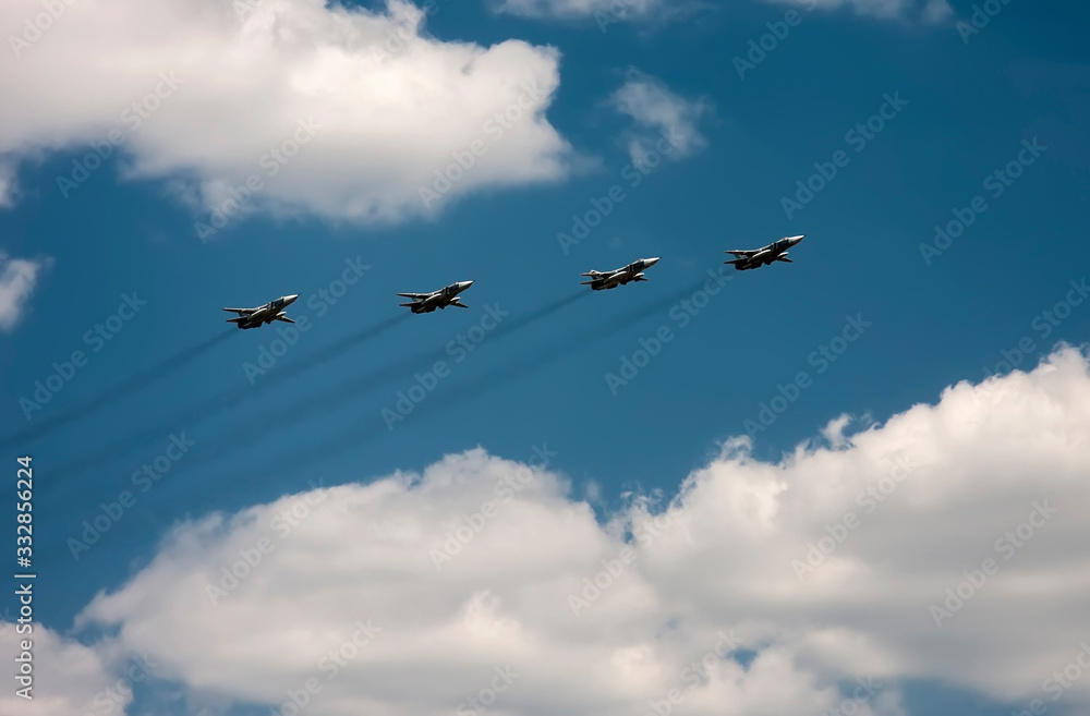 Fototapeta premium Airplanes fly against the blue sky and white clouds