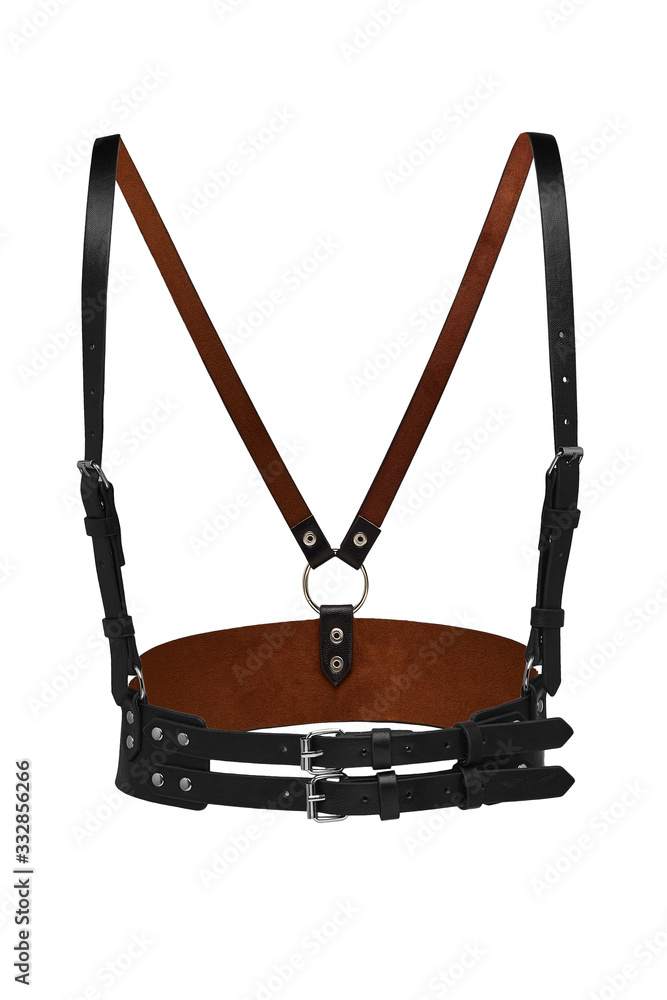 Subject shot of a black leather harness made as a wide belt with straps, steel buckles, rivets and rings. The chest harness is isolated on the white background. Subject shot of a black leather harness made as a wide belt with straps, steel buckles, rivets and rings. The chest harness is isolated on the white background.