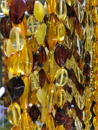 Amber beads in a jewelry store window. Jewelry design. Amber background of beads