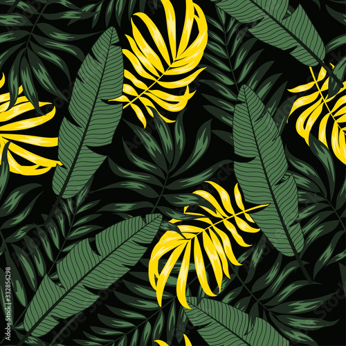 Summer seamless pattern with yellow and green tropical leaves and plants on a dark background. Illustration in Hawaiian style. Jungle leaves. Botanical pattern. Creative abstract background.