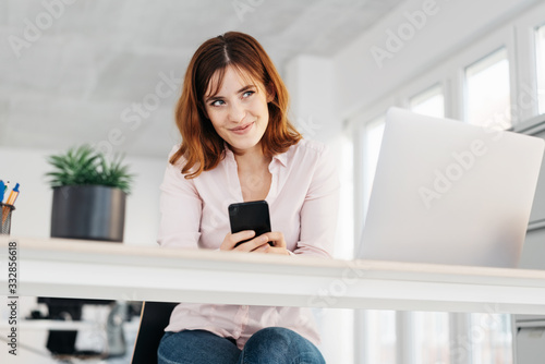 young woman looking up with a knowing smile