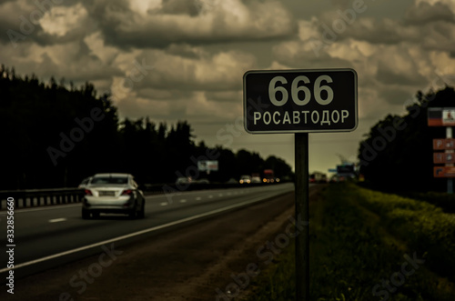 Принти на полотні Road sign 666 and cars on a country highway