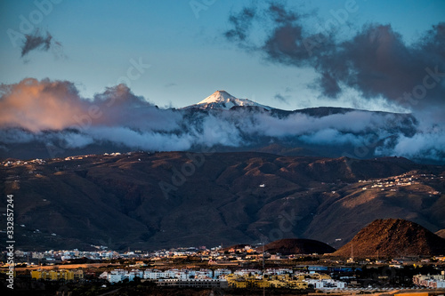 Beautiful landscape with city night lights and big vulcan mountain in background - beauty of tenerife spain