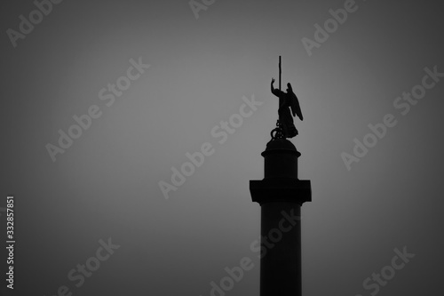 Dark silhouette of a statue against the sky