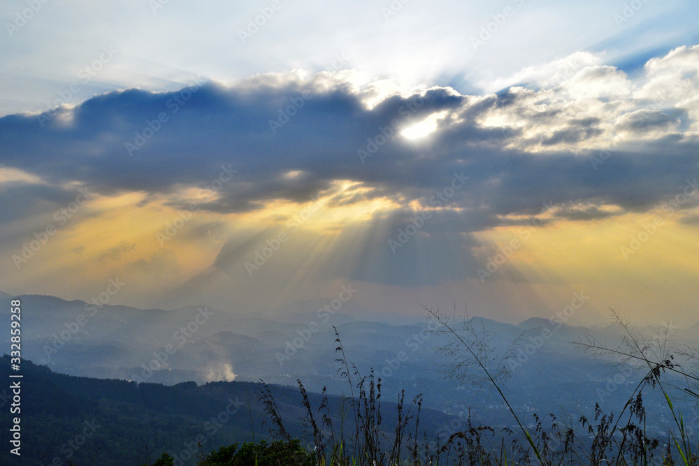 Beautiful View, twilight and sunset with beautiful large clouds.The sun is hidden from the clouds and sun rays are spreding out froum the clouds Beautiful View, twilight and sunset with beautiful large clouds.The sun is hidden from the clouds and sun rays are spreding out froum the clouds