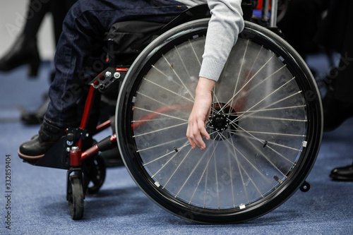 Details of an ill disabled young boy in a wheelchair.