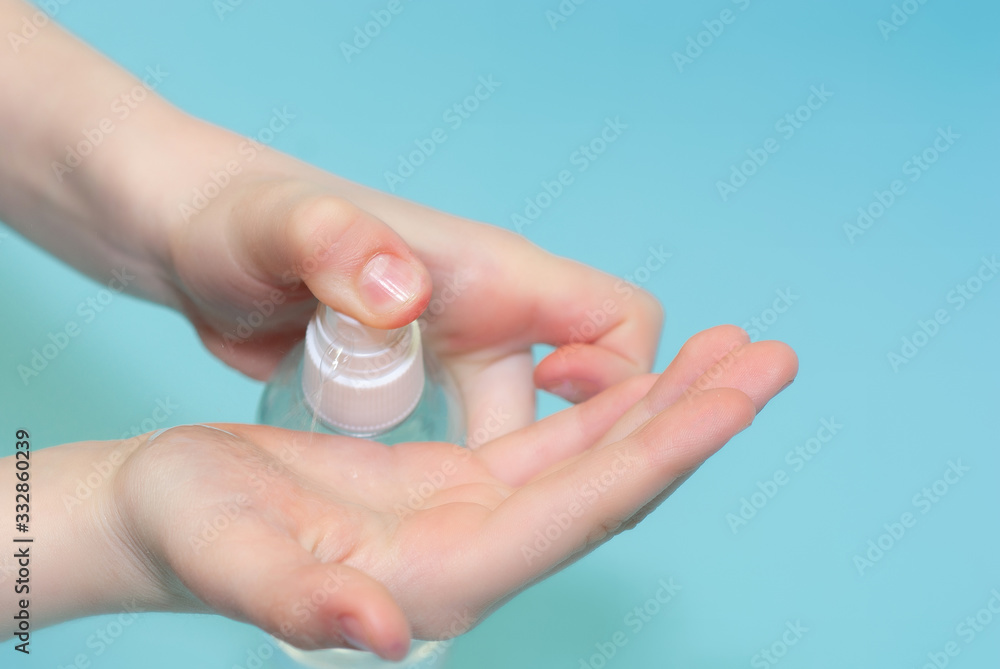 A child sprinkles an antiseptic on his hands. Virus protection. The use of chlorhexidine to protect against viruses and bacteria A child sprinkles an antiseptic on his hands. Virus protection. The use of chlorhexidine to protect against viruses and bacteria