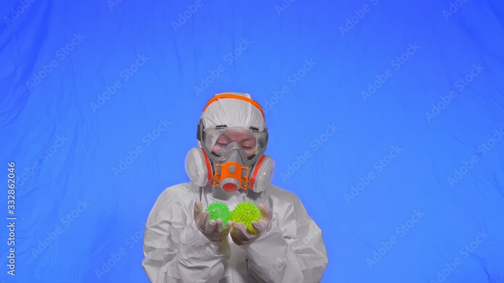 Doctor in respirator show a virus model concept health safety protection coronavirus epidemic 2019 nCoV. Slow motion. Woman wearing protect medical aerosol spray paint mask. Green ball spike thorn. Doctor in respirator show a virus model concept health safety protection coronavirus epidemic 2019 nCoV. Slow motion. Woman wearing protect medical aerosol spray paint mask. Green ball spike thorn.