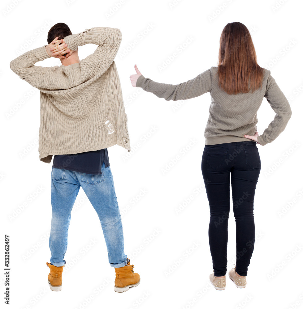 Back view of couple in sweater showing thumbs up. Back view of couple in sweater showing thumbs up.