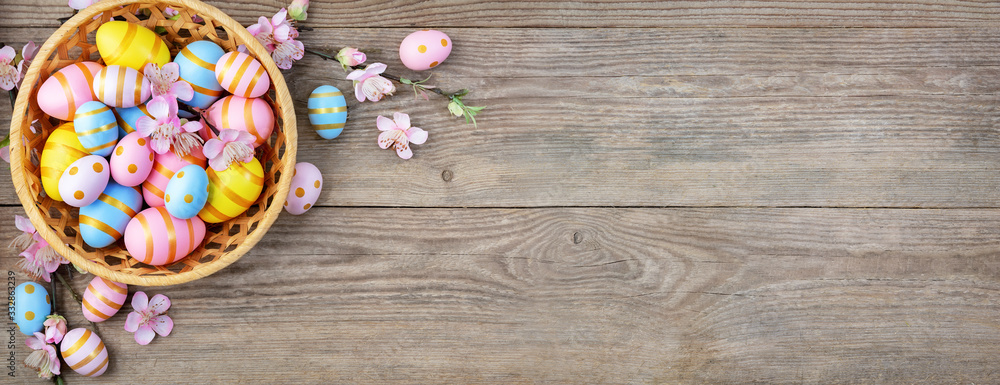 Gift card with colorful easter eggs on old wooden table.
