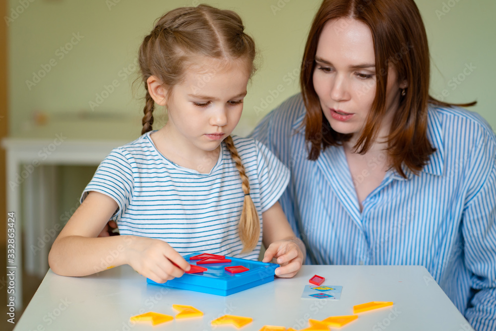 mom and girl solve mathematical puzzle. mom and girl solve mathematical puzzle.