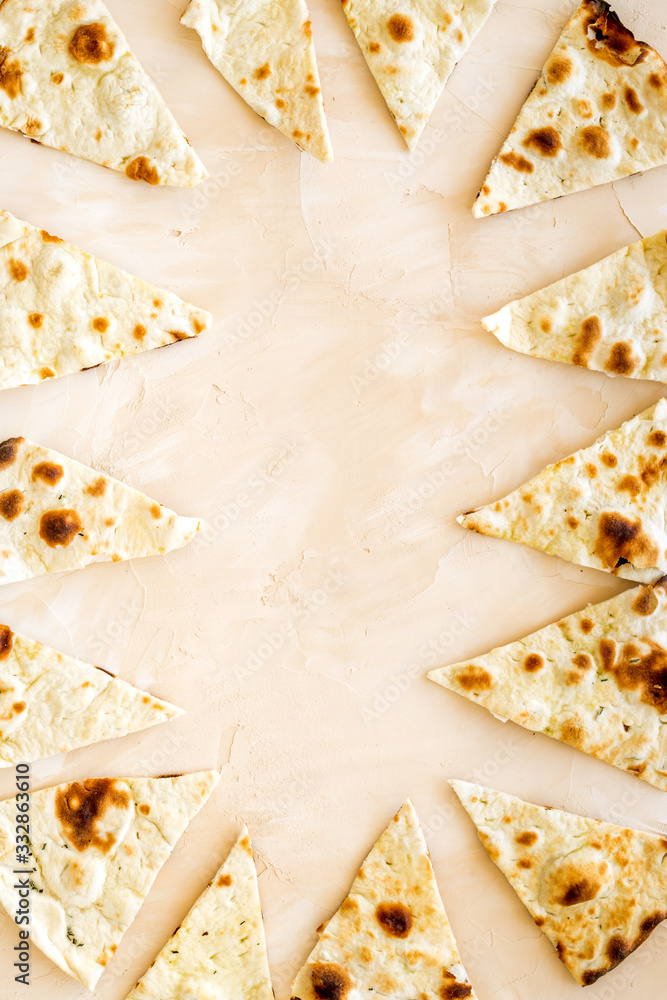 Focaccia pieces frame on beige background top-down copy space Focaccia pieces frame on beige background top-down copy space