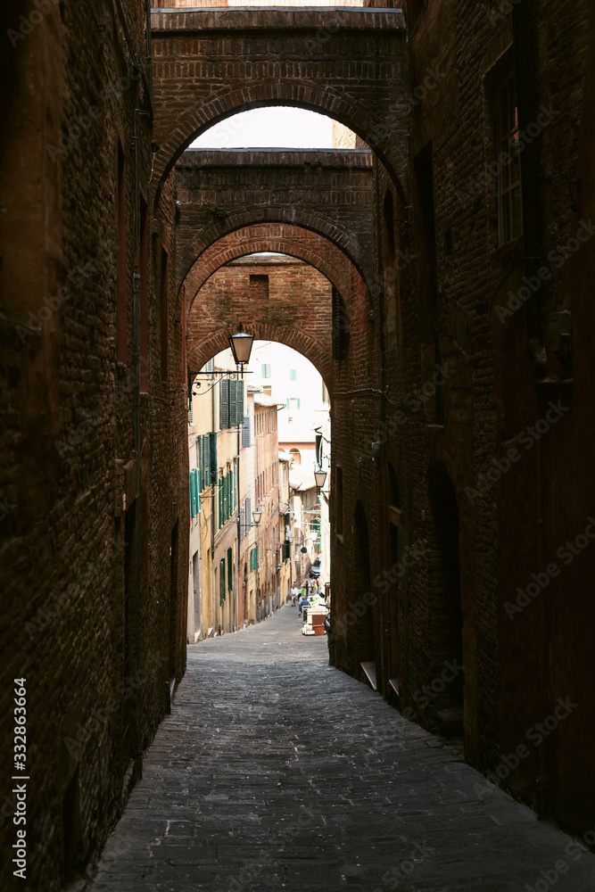 Beautiful street view of the ancient medieval city of Siena in Tuscany, Italy. Tourism in Europe