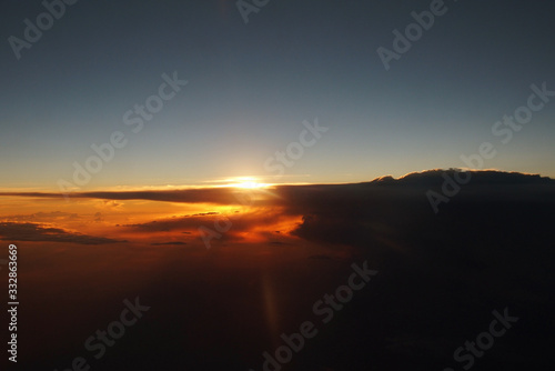  mysterious sunset with clouds from the airplane window with © Joanna Redesiuk