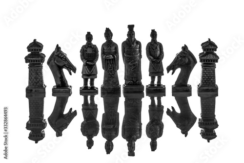 A view of silhouette several white chess pieces. Ceramic chess pieces against white color background