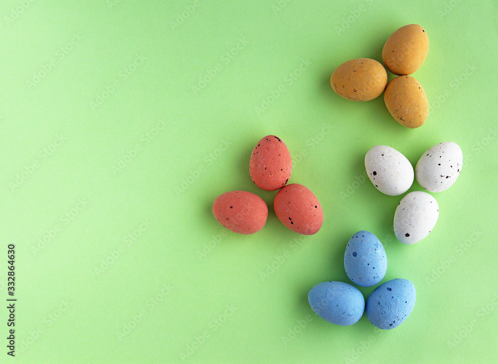 Easter eggs with different colors on a green background Easter eggs with different colors on a green background