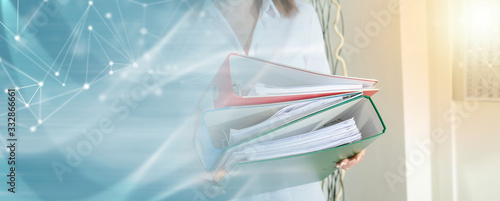 Obraz na plátně Businesswoman holding binders; panoramic banner