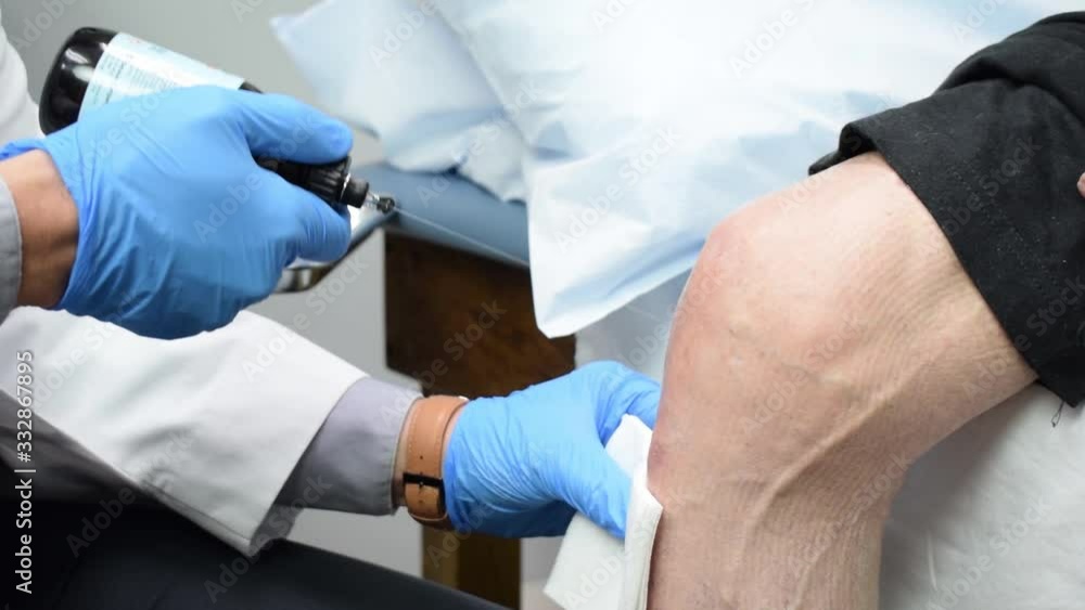 Medical Doctor Preparing and Injecting Platelet Rich Plasma PRP into Patient's Knee Medical Doctor Preparing and Injecting Platelet Rich Plasma PRP into Patient's Knee