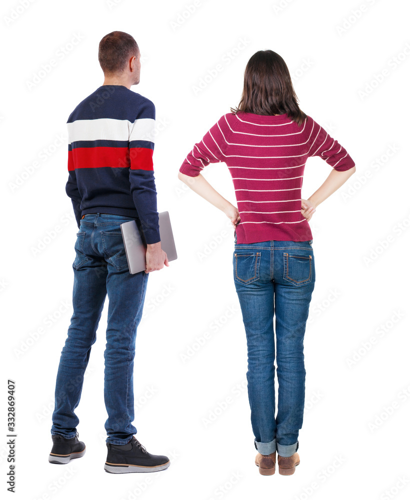 Naklejka premium Back view couple with laptop in sweater.
