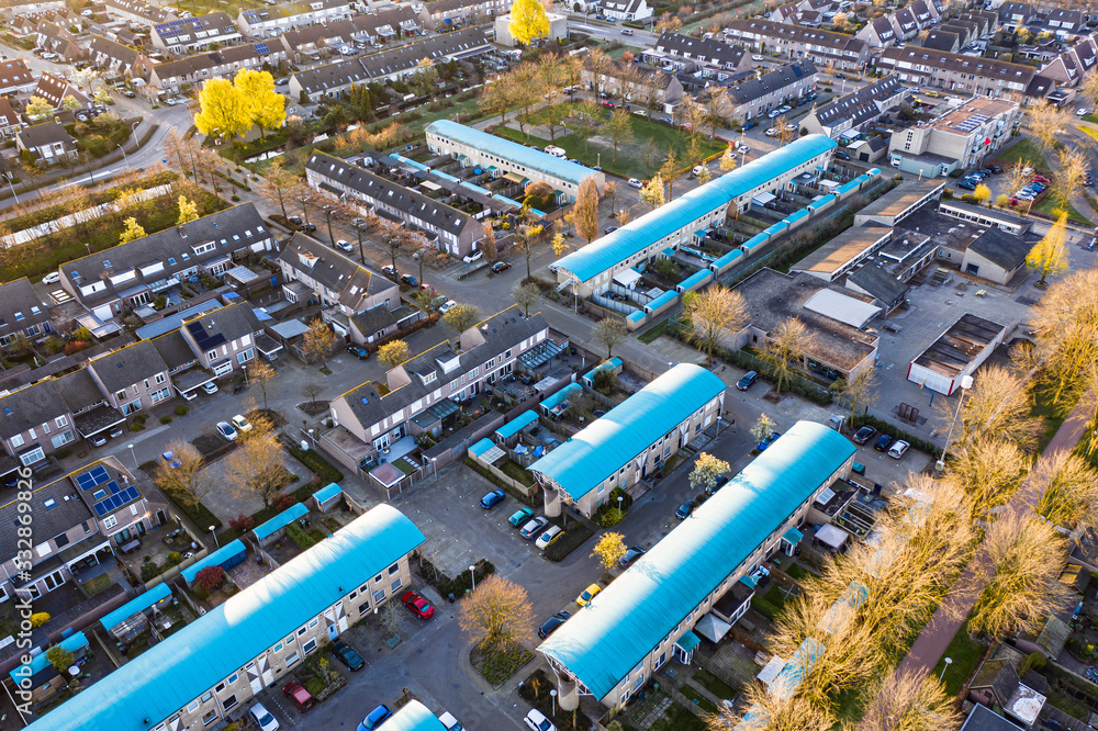 Fototapeta premium A residential area seen from above during a sunny sunrise in Waalwijk, Noord Brabant, Netherlands