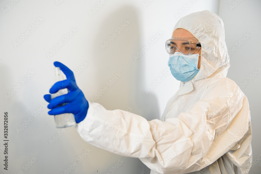 a doctor in a protective suit disinfects with an antiseptic. Coronavirus control concept. Quarantine. a doctor in a protective suit disinfects with an antiseptic. Coronavirus control concept. Quarantine.
