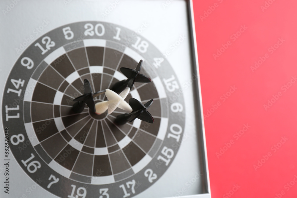 Different darts in board on red background. Career promotion concept Different darts in board on red background. Career promotion concept