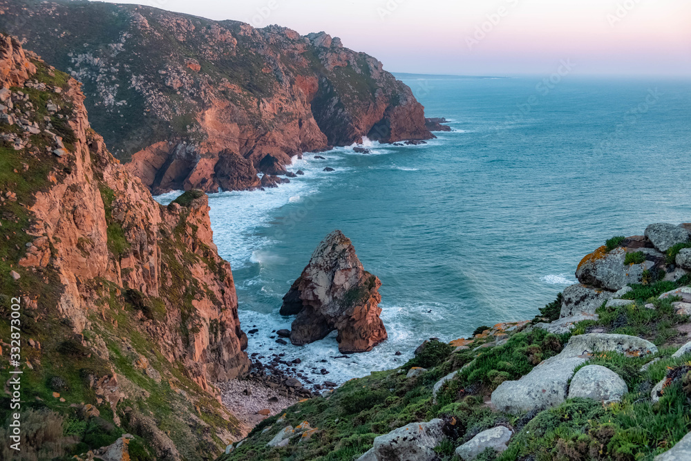 Cabo da Roca. View of the ocean and cliffs, rocks and mountains. Cape Roca is a cape which forms the westernmost point of the Sintra Mountain Range, of mainland Portugal, of continental Europe.