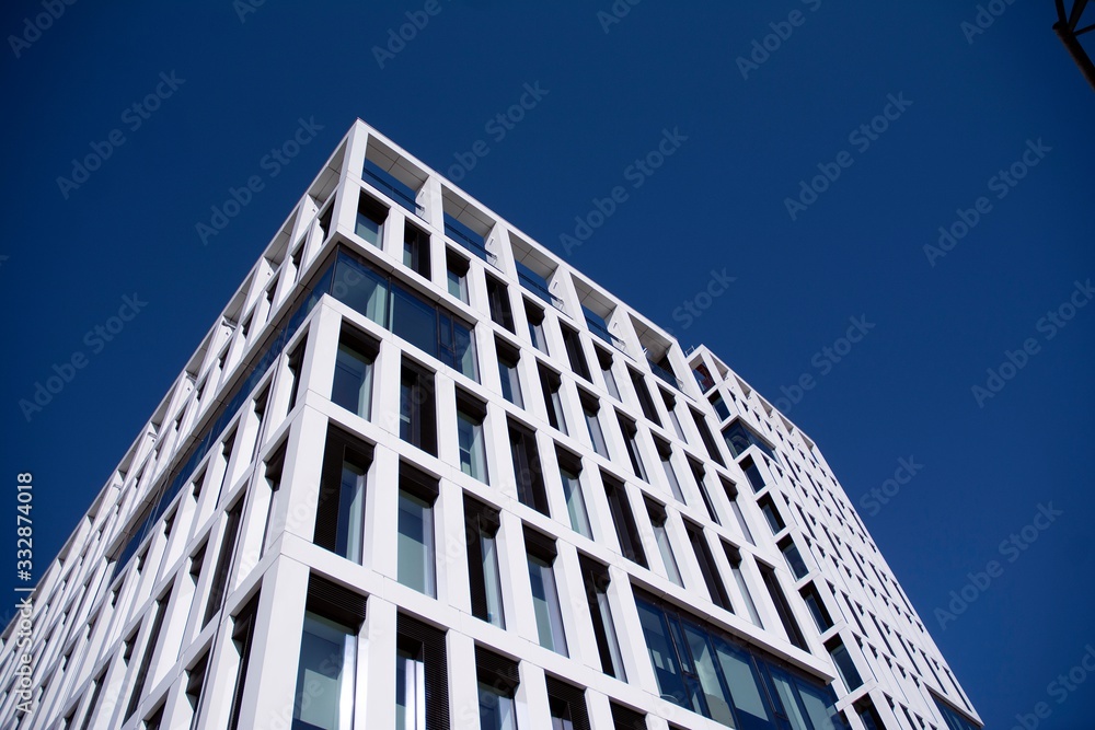 A part of modern business building against blue sky. Stylized modern office building.