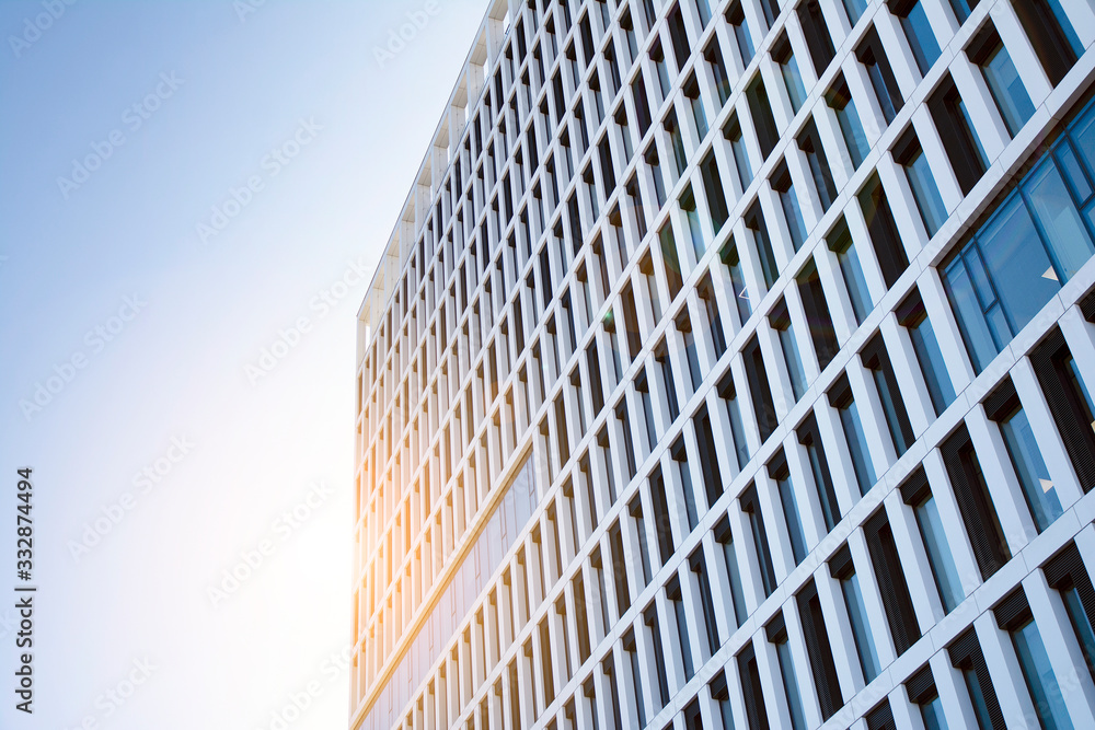 View of office building with sunrise, reflection and perspective. Bright outlook for business. Modern office block with sunny beautiful sky. View of office building with sunrise, reflection and perspective. Bright outlook for business. Modern office block with sunny beautiful sky.