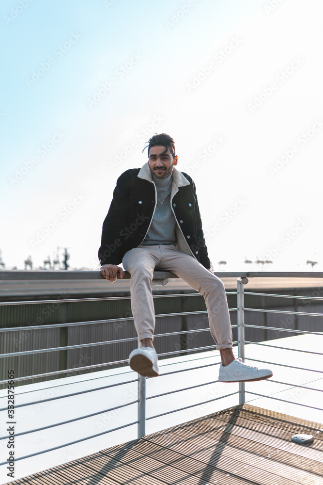 Young man posing on Rooftop in sunny weather, casual clothing Young man posing on Rooftop in sunny weather, casual clothing
