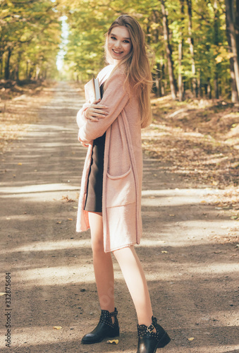  Girl holding a book in her hands smiling looking at the frame