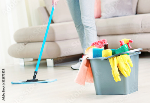 Woman clean the floor girl clean up the room bucket with sanitary items.