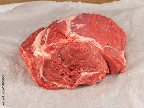 Canvas-taulu raw beef clod on white wrapping paper closeup