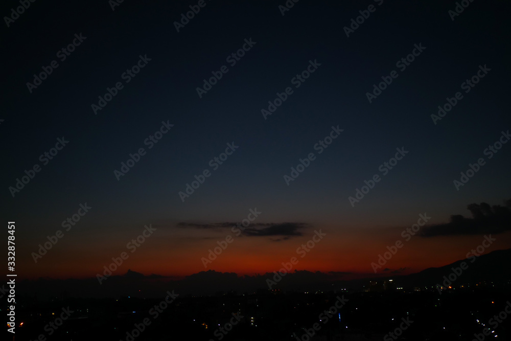 Naklejka premium dramatic dusk sky above the town