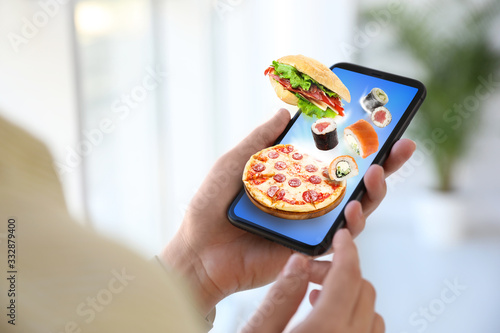 Woman using smartphone for ordering food online, closeup. Delivery service during quarantine photo