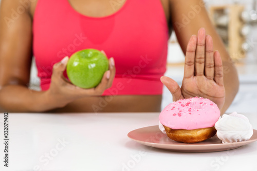 Fit Afro Girl Holding Apple And Doughnut