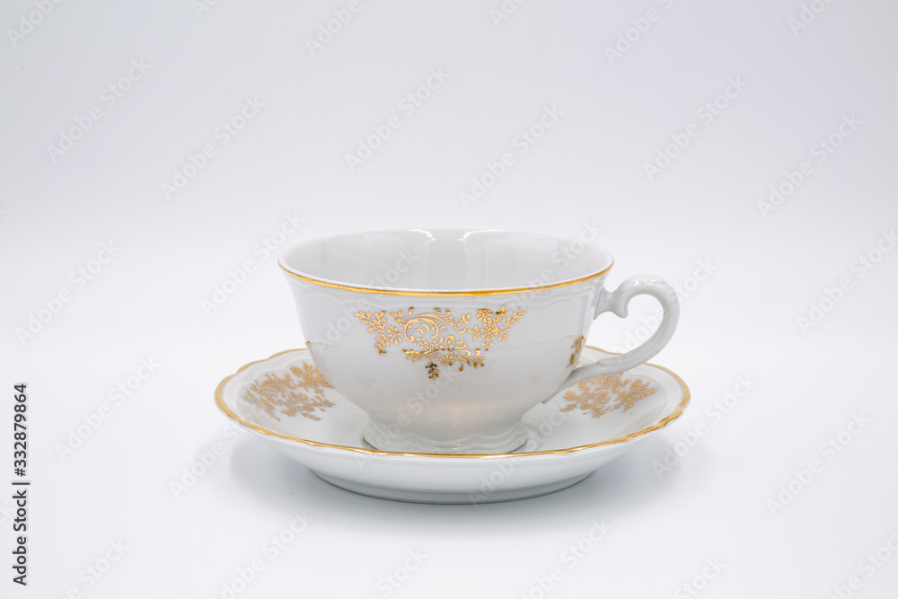 Vintage white tea cup with golden design in classic style isolated on white backg