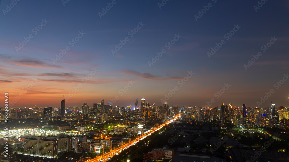 Panorama of cityscape with sunset over the building and blue sky at bangkok ,Thailand. View of the tall building in capital with twilight .Shot using Panorama technique.
