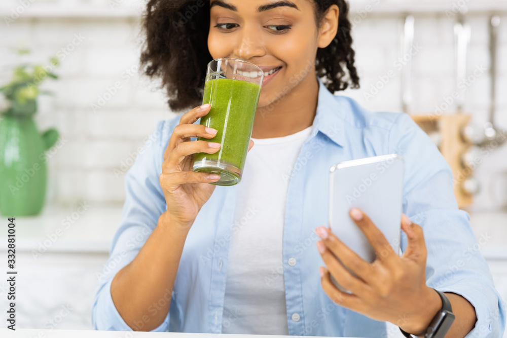 Afro Girl Drinking Smoothie And Checking Social Media Afro Girl Drinking Smoothie And Checking Social Media